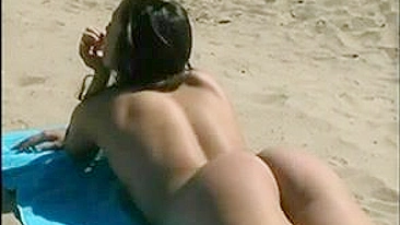 At The Beach, A Sexy, Naked Pussy Is Filmed