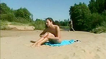 At The Beach, A Sexy, Naked Pussy Is Filmed