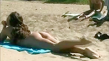 At The Beach, A Sexy, Naked Pussy Is Filmed