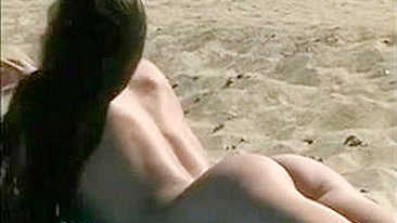 At The Beach, A Sexy, Naked Pussy Is Filmed