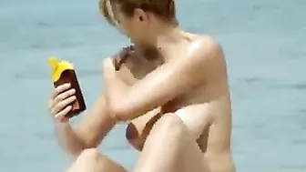 Sexy Girl With Big Boobs Oils Herself At Public Beach