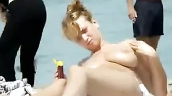 Sexy Girl With Big Boobs Oils Herself At Public Beach
