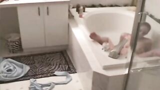 Spy, kink mom in the jacuzzi masturbates using a shower head and a jet of water