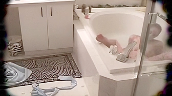 Spy, kink mom in the jacuzzi masturbates using a shower head and a jet of water