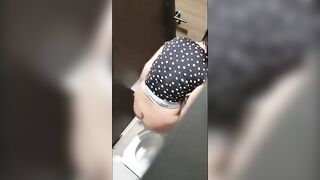 A beautiful lady was filmed with a hidden camera in the toilet with her panties down and fingering