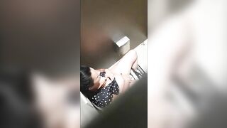 A beautiful lady was filmed with a hidden camera in the toilet with her panties down and fingering