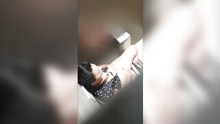 A beautiful lady was filmed with a hidden camera in the toilet with her panties down and fingering