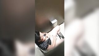 A beautiful lady was filmed with a hidden camera in the toilet with her panties down and fingering