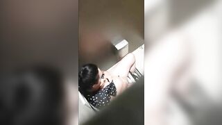 A beautiful lady was filmed with a hidden camera in the toilet with her panties down and fingering