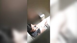 A beautiful lady was filmed with a hidden camera in the toilet with her panties down and fingering