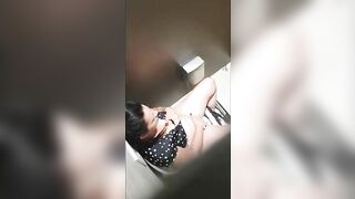 A beautiful lady was filmed with a hidden camera in the toilet with her panties down and fingering