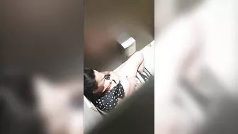 A beautiful lady was filmed with a hidden camera in the toilet with her panties down and fingering
