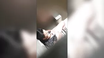 A beautiful lady was filmed with a hidden camera in the toilet with her panties down and fingering