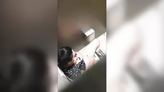 A beautiful lady was filmed with a hidden camera in the toilet with her panties down and fingering