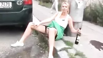 Drunk German woman pisses on street with beer
