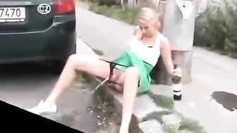 Drunk German woman pisses on street with beer