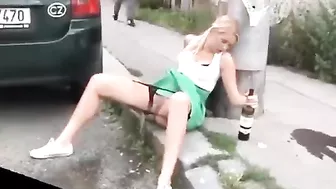 Drunk German woman pisses on street with beer