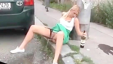 Drunk German woman pisses on street with beer