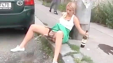 Drunk German woman pisses on street with beer