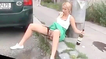 Drunk German woman pisses on street with beer