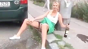 Drunk German woman pisses on street with beer