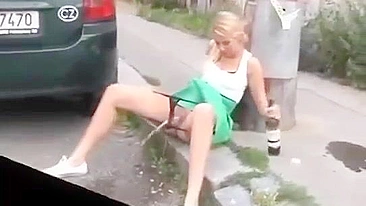 Drunk German woman pisses on street with beer
