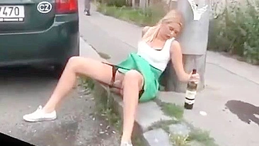 Drunk German woman pisses on street with beer